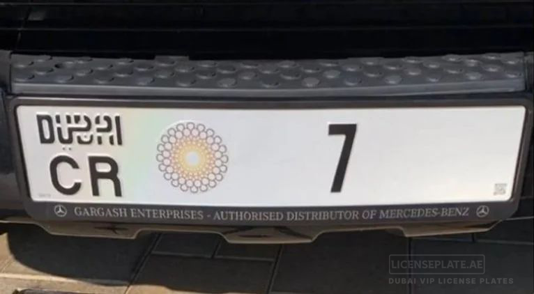 Close-up of Dubai license plate CR 7 on a vehicle bumper.